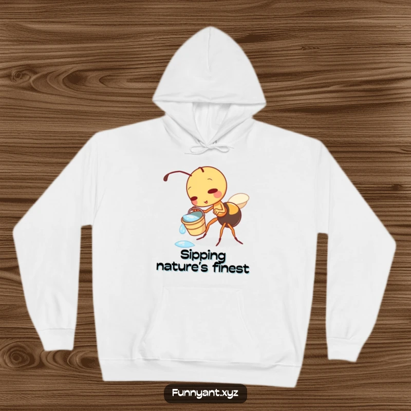 Funny hoodie depicting a cute ant character playfully tipping a small bucket of refreshing dewdrops, perfect for cozy, fun-loving individuals.